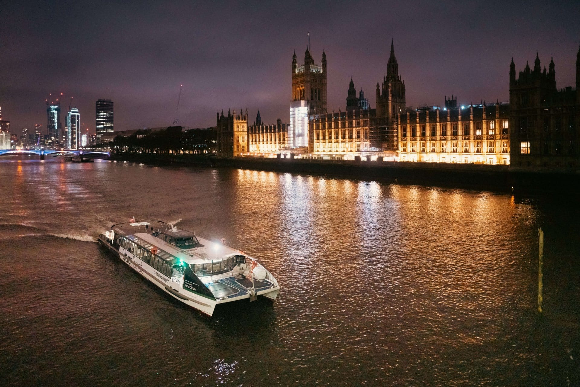 Londres de noche: barco por el río iluminado
